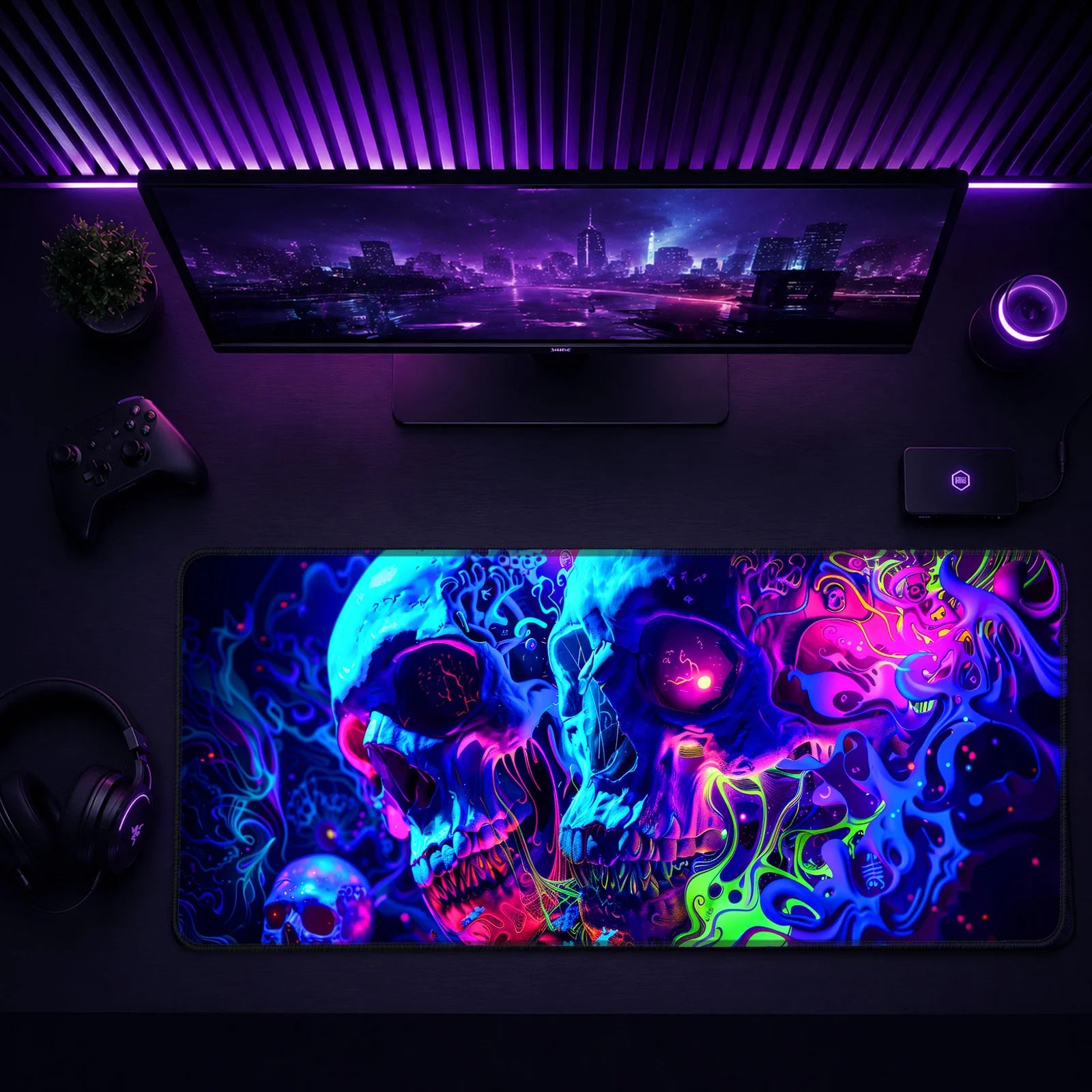 A minimalist gaming desk with ultrawide monitor, purple LED backlighting, controller, headphones, and a large neon skull mouse pad.